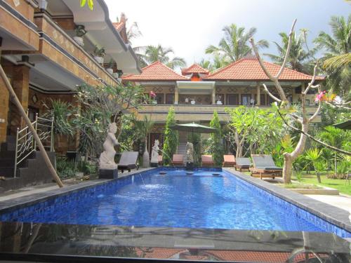 a swimming pool in front of a house at Nitya Home Stay Lembongan in Nusa Lembongan
