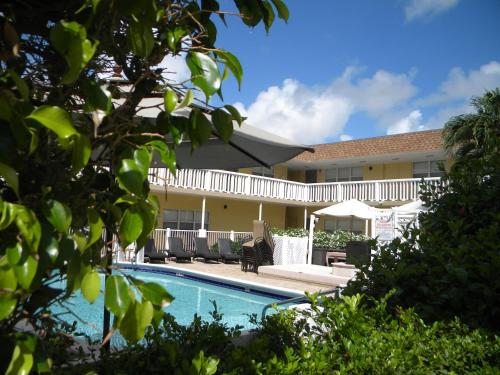 a resort with a swimming pool in front of a building at Pompano Beach Hidden Gem in Pompano Beach