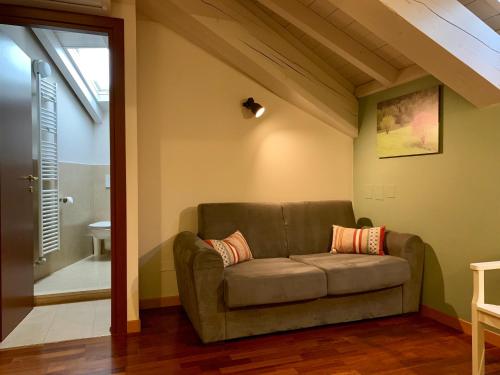 a couch in the corner of a room at Porta Ronca - B&B, Suites & Apts in Rho