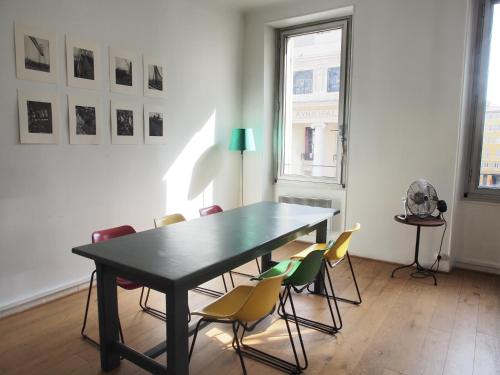 une salle à manger avec une table et des chaises noires dans l'établissement Home Opéra, à Marseille