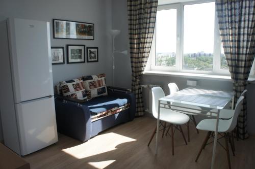 a small kitchen with a table and a table and chairs at Astoria Club in Oryol