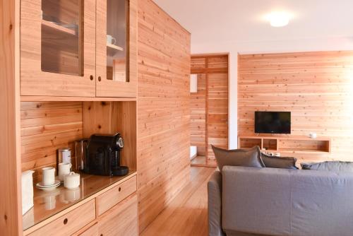 a living room with wooden walls and a blue couch at Porto Pim Bay in Horta