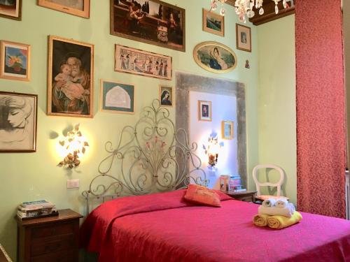 a bedroom with a bed with a red blanket at La Stagione dell'Arte in Camaiore