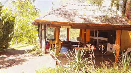 Casa con porche con mesa y sillas en Complejo De Cabanas Von Liss en Salsipuedes