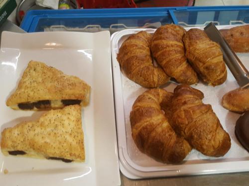 a tray of pastries and croissants on a table at Hotel Español in La Pueblanueva