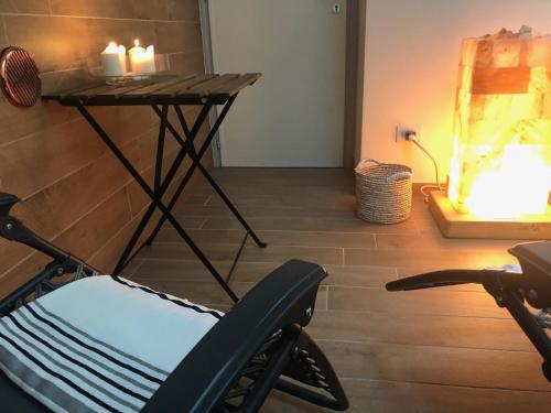 a room with a table and a chair and a fireplace at Relais Dei Mandorli in Bergamo