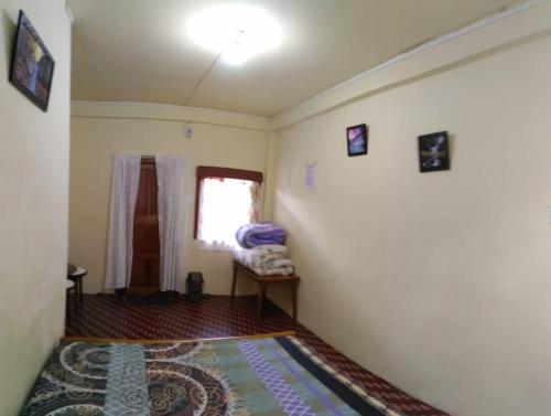 a small room with a bed and a window at Goshen homestay in Cherrapunji