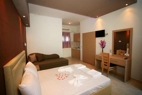 a hotel room with a table and a living room at Studios Ristas 2 in Parga