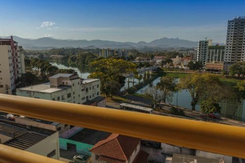 a view of a river in a city with buildings at Hotel Vila Rica Flat in Resende