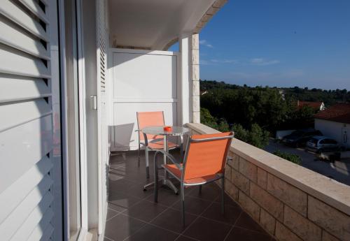 a patio with two chairs and a table on a balcony at Villa Marijeta Hvar in Hvar