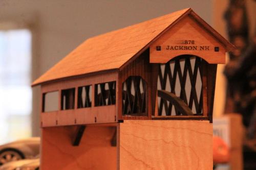 a model of a wooden house is shown at The Lodge at Jackson Village in Jackson