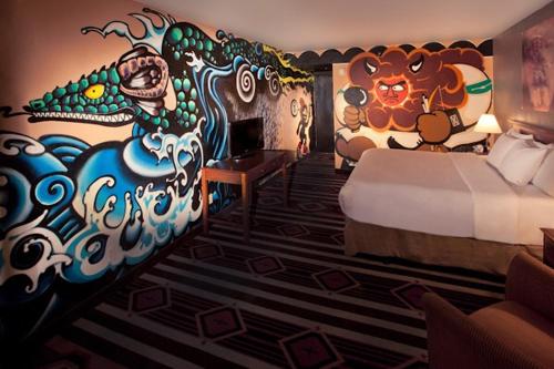 a bedroom with a mural of a lion and a bed at Nativo Lodge in Albuquerque