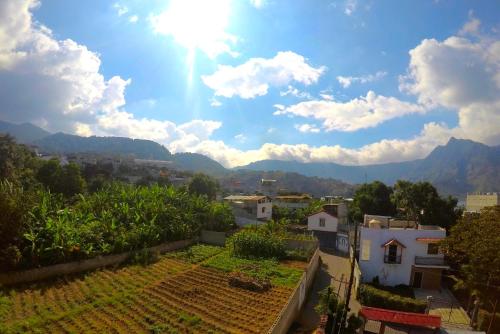 a view of a town with mountains in the background at Hospedaje Lolita in San Pedro La Laguna