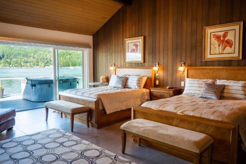 a bedroom with two beds and a window at Walls of Glass Hood Canal Vacation Rental in Union
