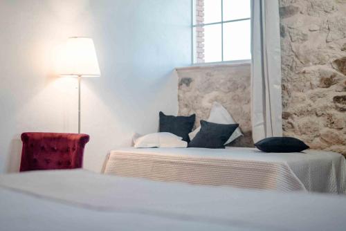 a bedroom with two beds with pillows and a lamp at Chambres d'Hôtes Le Pignié in Lescure-dʼAlbigeois