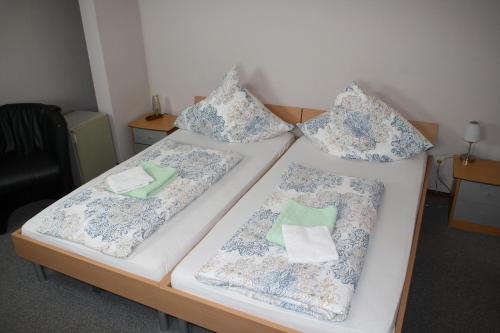 two beds with pillows on them in a room at Hotel Restaurant Balkan in Trier