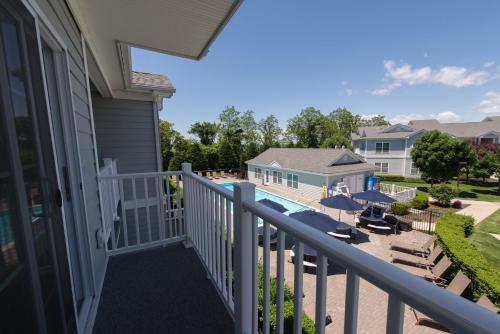 a balcony with a view of a pool and chairs at The Cliffside Resort Condominiums in Greenport