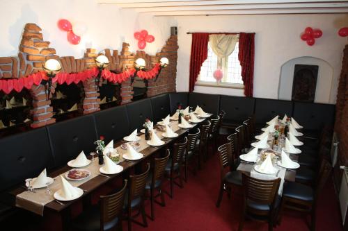 a row of tables and chairs in a room at Hotel Restaurant Balkan in Trier