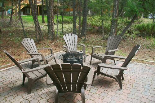 a group of four chairs and a table in a patio at Falcon Cabin in Fairmont Hot Springs