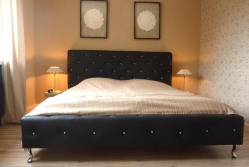 - un grand lit dans une chambre avec deux lampes dans l'établissement "Stine", à Westerland