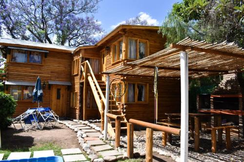 a log cabin with a staircase in front of it at Infinito Chill0ut in San Marcos Sierras