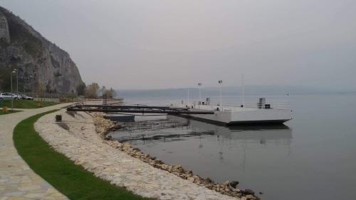 a boat is docked at a dock on the water at Sobe Seka in Golubac