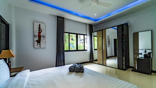 a bedroom with a bed with two goggles on it at Sunset Paradise Villa in Haad Pleayleam