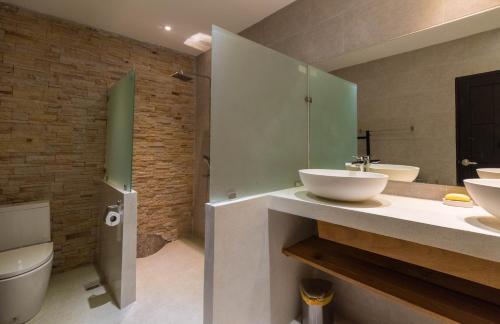 a bathroom with two sinks and a toilet at Sunset Paradise Villa in Haad Pleayleam