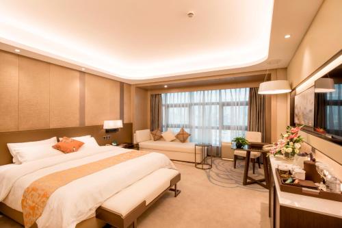 Postel nebo postele na pokoji v ubytování Jin Jiang Pine City Hotel