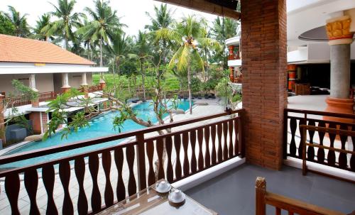 a view from the balcony of a resort with a swimming pool at Green Field Resort Ubud in Ubud