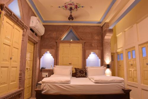 a bedroom with two beds and a ceiling at Suraj Haveli in Jodhpur