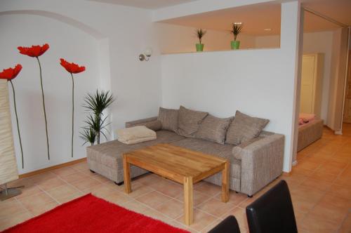 a living room with a couch and a table at Zum Goldenen Anker in Stralsund