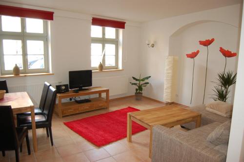 a living room with a couch and a table at Zum Goldenen Anker in Stralsund