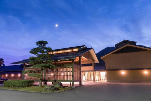 a building with a tree in front of it at Kashoen in Hanamaki