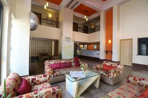 a living room with couches and a table in a building at VITS Kamats Resort, Silvassa in Silvassa