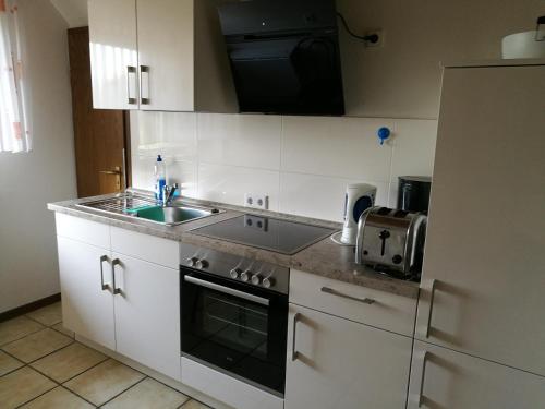 a kitchen with a sink and a stove top oven at Haus Schütte in Erwitte