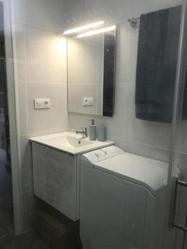 a bathroom with a sink and a mirror at 22B puigmal D in Empuriabrava
