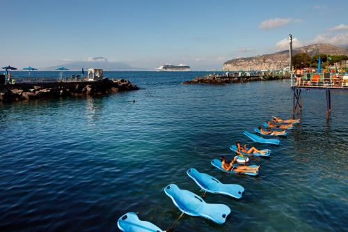 a group of people laying on kayaks in the water at Sorrento Flats in Sorrento