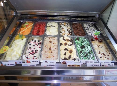 a display case filled with lots of different types of cakes at Gasthof Gosauschmied in Gosau