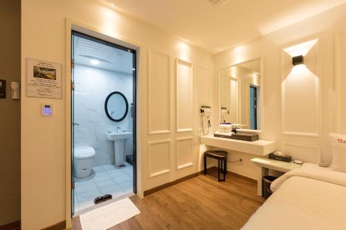 a bathroom with a shower and a sink and a toilet at Stay Hotel in Gwangju