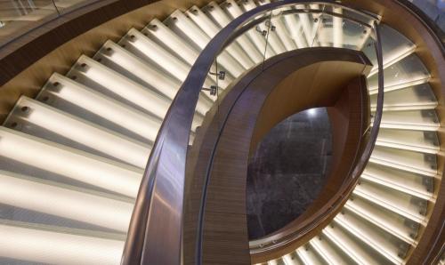 a spiral staircase in a building with windows at Hotel ICON in Hong Kong