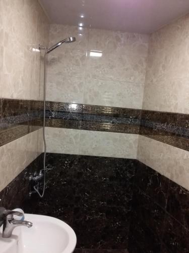 a bathroom with a sink and a shower at Guest House Medea in Tʼelavi