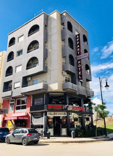 a building with a car parked in front of it at Appart Hotel Tanger Paname in Tangier