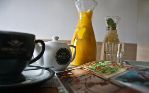 a table with a cup of coffee and some bottles at Hotel Górski Czarna Góra in Stronie Śląskie