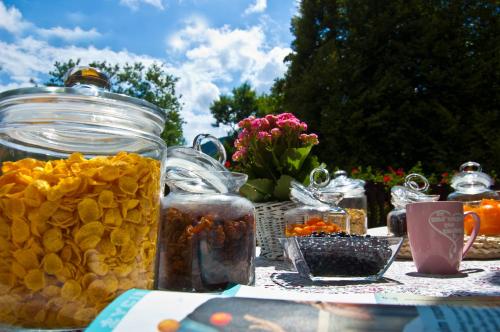 a table with jars of food and flowers on it at Hotel Górski Czarna Góra in Stronie Śląskie