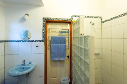 a bathroom with a sink and a blue towel at Palm View in Laborie