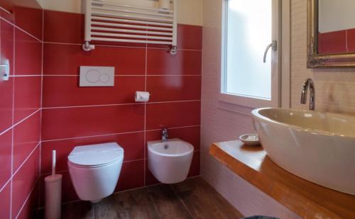 a bathroom with a white toilet and a sink at Barbara’s rooms in Chioggia