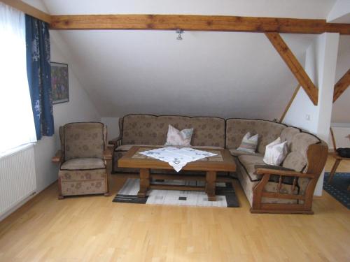 a living room with a couch and a coffee table at Landhaus-Stockinger in Büchlberg