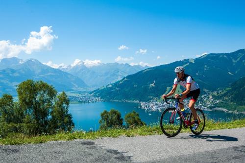 a man riding a bike on a mountain road at Aparthotel Zell am See (Contactless Check-In) in Zell am See