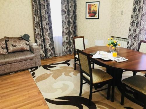 a living room with a table and a couch at Sultan Beibarys in Astana